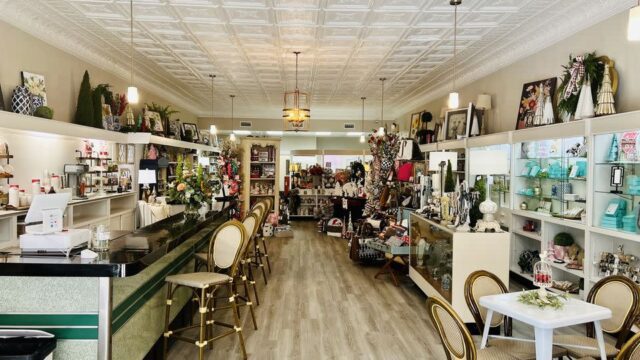 The interior of a store with a long counter and merchandise displayed on shelves