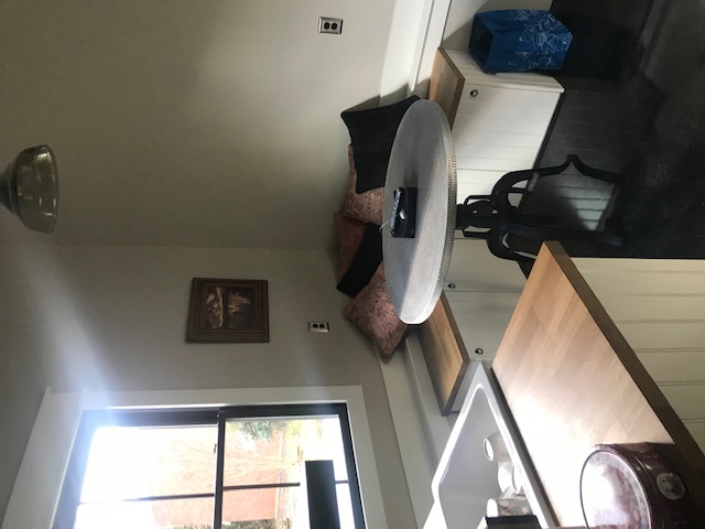 A small round table in front of banquette seating