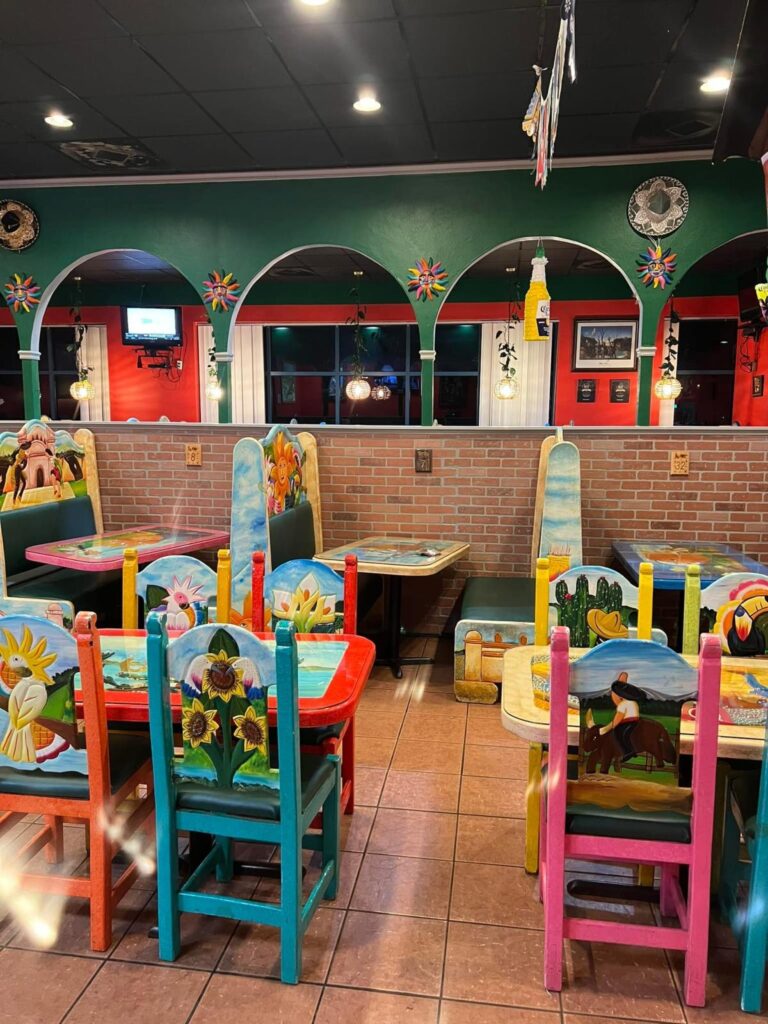Colorful painted wooden tables and chairs at a Mexican restaurant