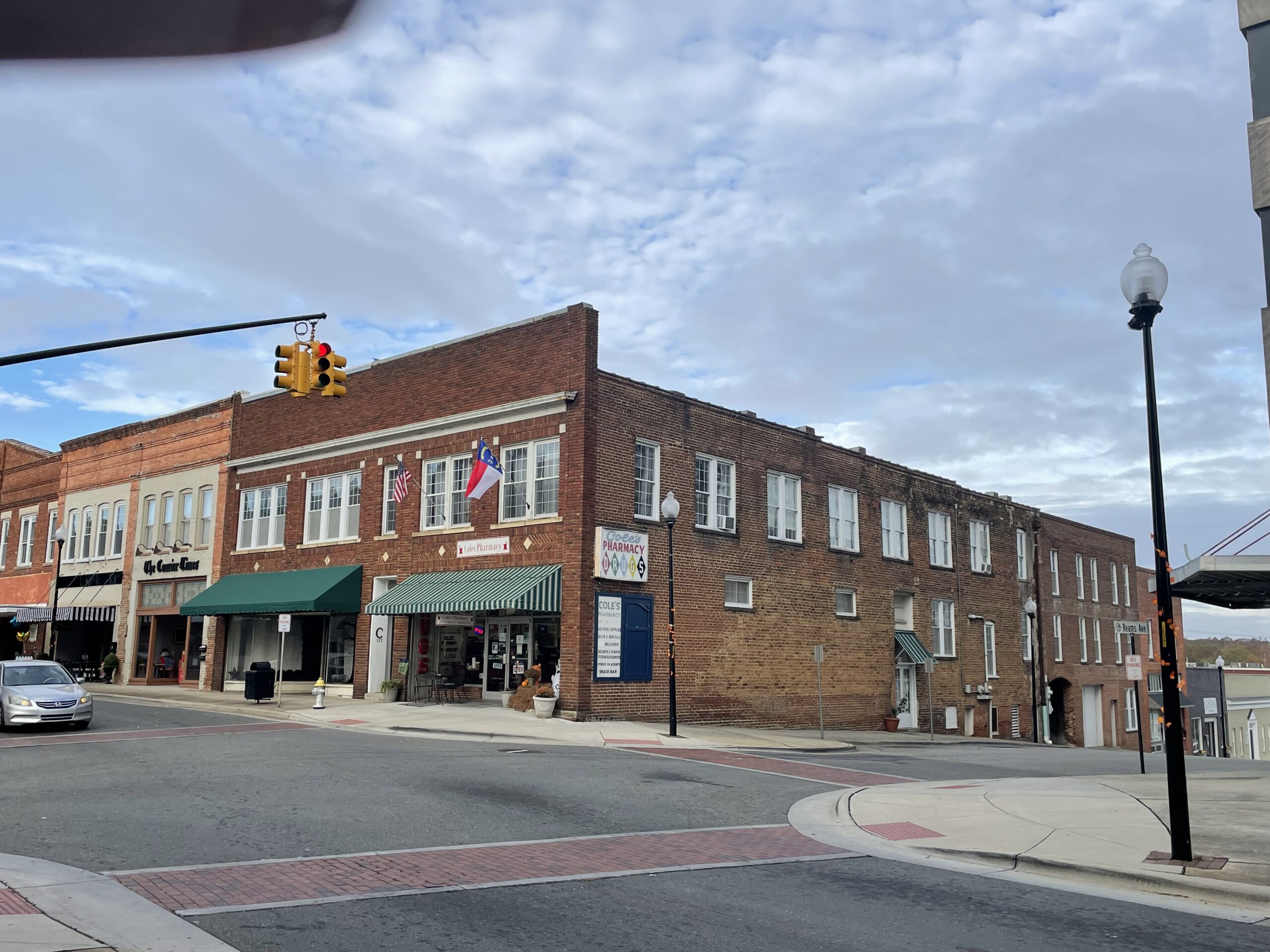 A street corner in Roxboro with red brick buildings